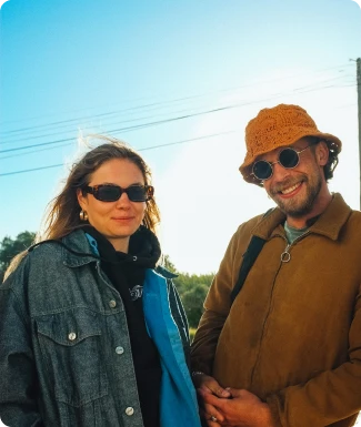 Two people with glasses smiling