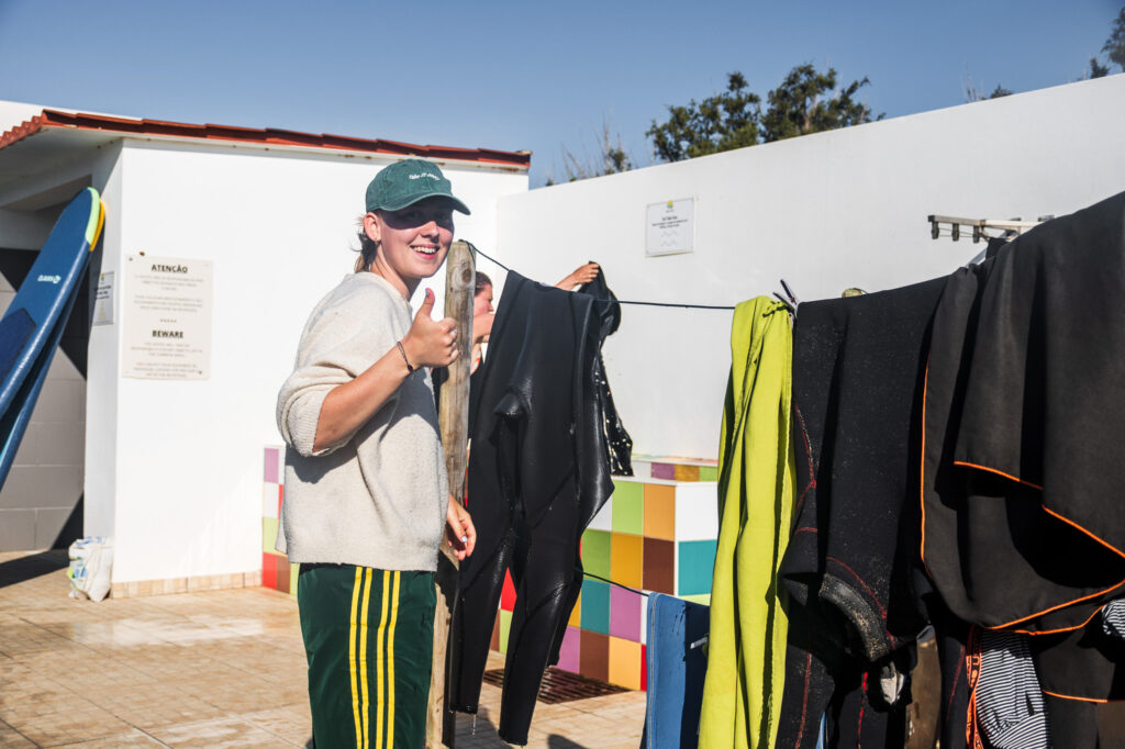 people getting ready to surf in portugal