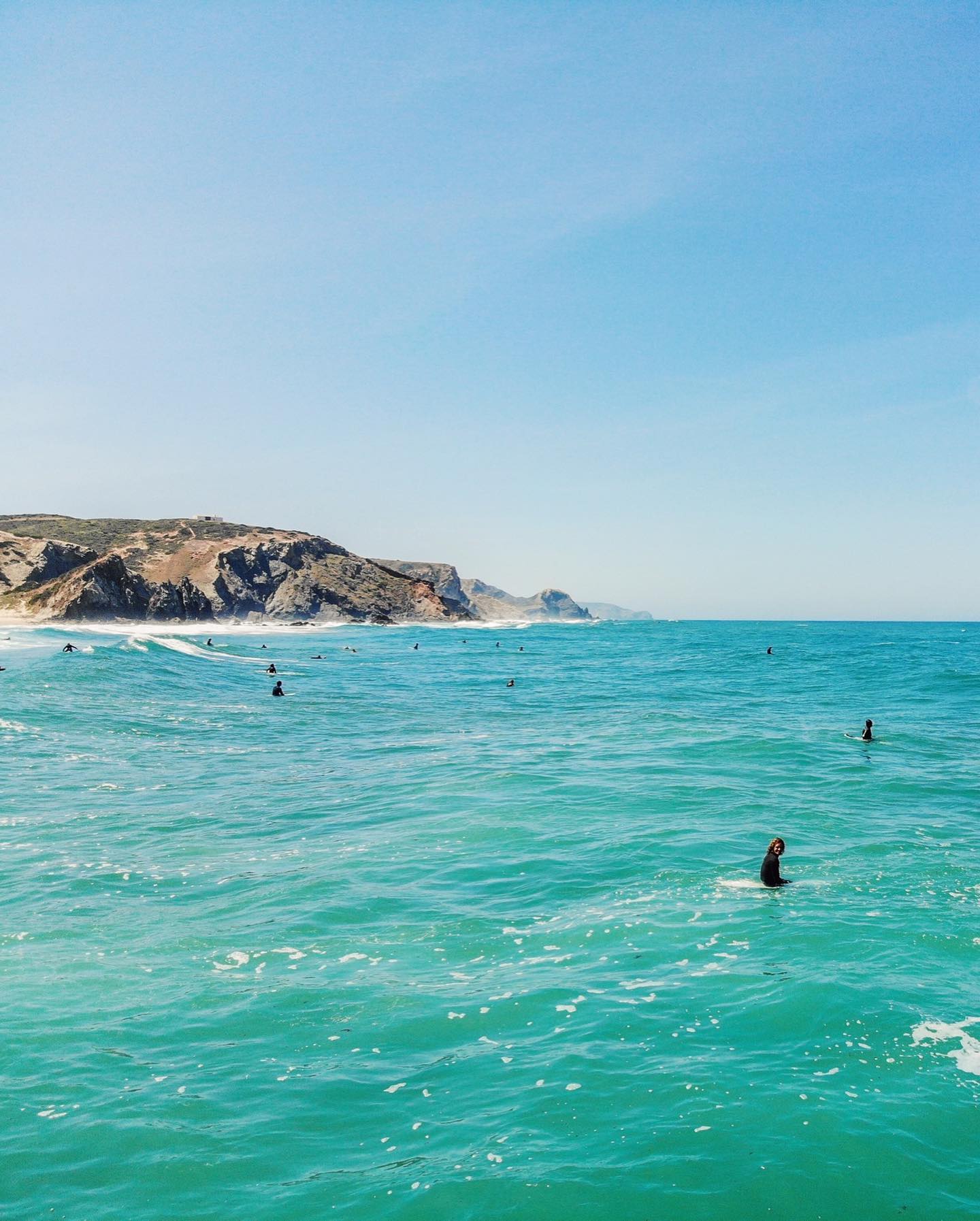 surfers in vila do bispo beach